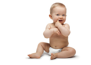 Sweet little boy sitting with finger in the mouth